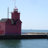The SS Keewatin (in distance) sails past Holland Harbor Monday on its way to its new home in Ontario, Canada.