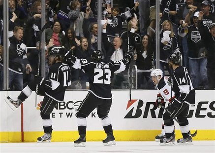 Los Angeles Anze Kopitar (L) celebrates with teammates Dustin Brown (2nd L) and Justin Williams (R) as New Jersey Devils Zach Parise skates Los Angeles Anze Kopitar (L) celebrates with teammates Dustin Brown (2nd L) and Justin Williams (R) as New Jersey Devils Zach Parise skates