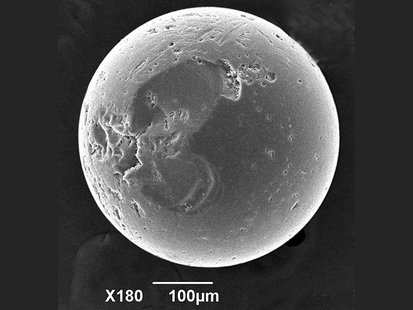 A glass bead with divots and scratches is pictured in this handout scanning electron microscope image obtained by Reuters June 1, 2012. REUT A glass bead with divots and scratches is pictured in this handout scanning electron microscope image obtained by Reuters June 1, 2012. REUT
