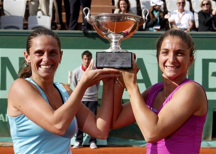 Sara Errani (R) and Roberta Vinci of Italy pose with their trophy after winning their women's doubles final against Maria Kirilenko of Russi Sara Errani (R) and Roberta Vinci of Italy pose with their trophy after winning their women's doubles final against Maria Kirilenko of Russi