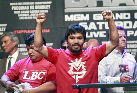 Filipino boxer Manny Pacquiao poses for fans during an official weigh-in at the MGM Grand Garden Arena in Las Vegas, Nevada June 8, 2012. RE Filipino boxer Manny Pacquiao poses for fans during an official weigh-in at the MGM Grand Garden Arena in Las Vegas, Nevada June 8, 2012. RE