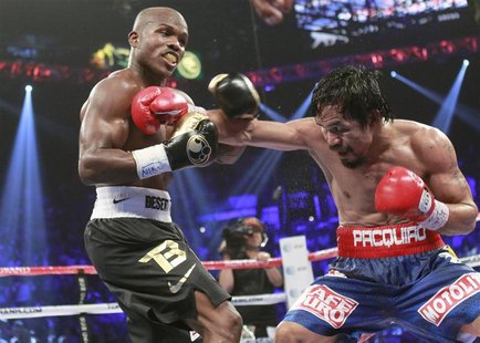 Timothy Bradley Jr. (L) of the U.S. exchanges blows with WBO welterweight champion Manny Pacquiao of the Philippines during their title figh Timothy Bradley Jr. (L) of the U.S. exchanges blows with WBO welterweight champion Manny Pacquiao of the Philippines during their title figh