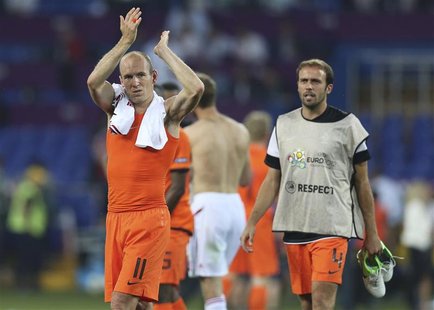 Netherlands' Arjen Robben (L) and Joris Mathijsen react after the Group B Euro 2012 soccer match against Denmark at the Metalist stadium in Netherlands' Arjen Robben (L) and Joris Mathijsen react after the Group B Euro 2012 soccer match against Denmark at the Metalist stadium in