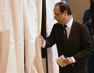 France's President Francois Hollande enters the voting booth in the legislative elections at the polling station in Tulle June 10, 2012. REU France's President Francois Hollande enters the voting booth in the legislative elections at the polling station in Tulle June 10, 2012. REU