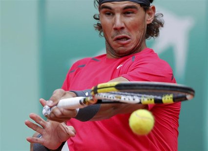 Rafael Nadal of Spain returns the ball to Novak Djokovic of Serbia during their men's singles final match at the French Open tennis tourname Rafael Nadal of Spain returns the ball to Novak Djokovic of Serbia during their men's singles final match at the French Open tennis tourname