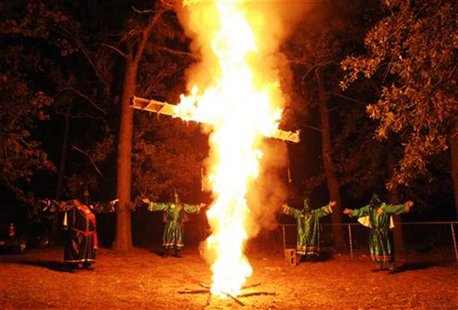 Members of the Ku Klux Klan (KKK) participate in a cross lighting ceremony at a Klansman's home in Warrenville, South Carolina October 23, 2 Members of the Ku Klux Klan (KKK) participate in a cross lighting ceremony at a Klansman's home in Warrenville, South Carolina October 23, 2