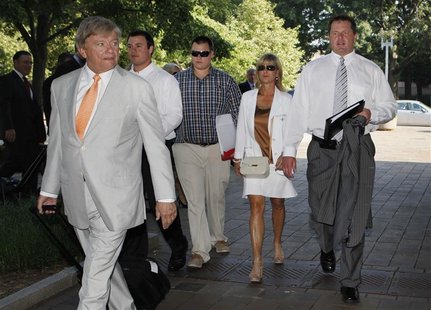 Former Major League pitcher Roger Clemens (R) and his wife Debbie (2nd R), walk behind his attorney Rusty Hardin (front) as they arrive for Former Major League pitcher Roger Clemens (R) and his wife Debbie (2nd R), walk behind his attorney Rusty Hardin (front) as they arrive for