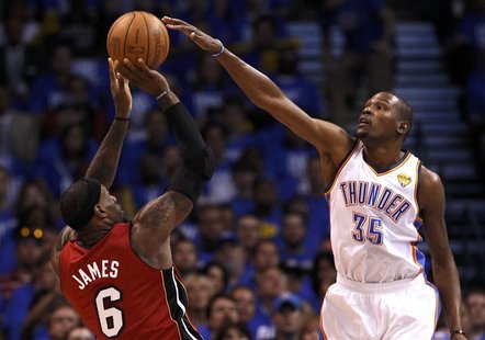 Miami Heat's LeBron James (L) is guarded by Oklahoma City Thunder's Kevin Durant during the first quarter in Game 1 of the NBA basketball fi Miami Heat's LeBron James (L) is guarded by Oklahoma City Thunder's Kevin Durant during the first quarter in Game 1 of the NBA basketball fi