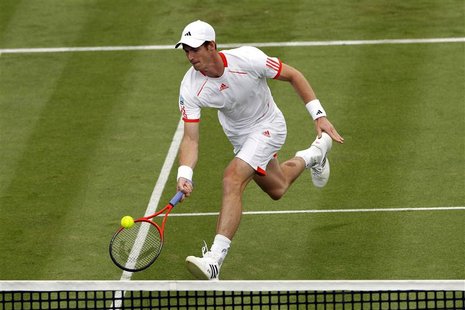 Andy Murray of Britain returns the ball to Nicolas Mahut of France during their men's singles tennis match at the Queen's Club tournament in Andy Murray of Britain returns the ball to Nicolas Mahut of France during their men's singles tennis match at the Queen's Club tournament in