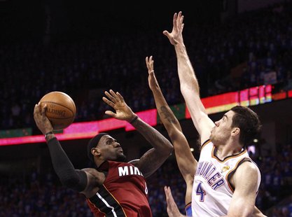 Miami Heat's LeBron James (L) is guarded by Oklahoma City Thunder's Nick Collison during the fourth quarter in Game 1 of the NBA basketball Miami Heat's LeBron James (L) is guarded by Oklahoma City Thunder's Nick Collison during the fourth quarter in Game 1 of the NBA basketball