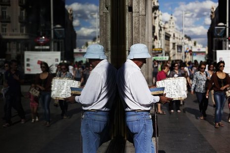Alberto Tojeira Simoes, from Portugal, begs for money in Madrid's commercial district June 11, 2012. Financial market euphoria over a Europe Alberto Tojeira Simoes, from Portugal, begs for money in Madrid's commercial district June 11, 2012. Financial market euphoria over a Europe
