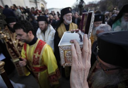 A Bulgarian East-Orthodox priest holds up a box containing bones, believed to be the relics of John the Baptist, in front golden-domed "Alex A Bulgarian East-Orthodox priest holds up a box containing bones, believed to be the relics of John the Baptist, in front golden-domed "Alex