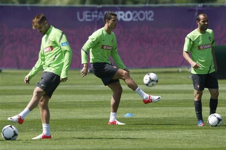 Portugal's Cristiano Ronaldo (C) controls the ball during a training session for the Euro 2012 at a training field in Opalenica June 15, 201 Portugal's Cristiano Ronaldo (C) controls the ball during a training session for the Euro 2012 at a training field in Opalenica June 15, 201