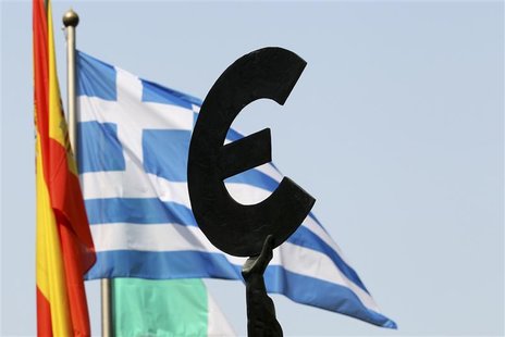 A Greek flag flies behind a statue to European unity outside the European Parliament in Brussels ahead of an EU informal heads of state summ A Greek flag flies behind a statue to European unity outside the European Parliament in Brussels ahead of an EU informal heads of state summ