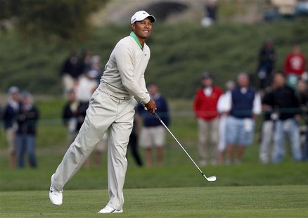Tiger Woods watches his second shot on the 17th hole during the third round of the 2012 U.S. Open golf tournament on the Lake Course at the Tiger Woods watches his second shot on the 17th hole during the third round of the 2012 U.S. Open golf tournament on the Lake Course at the