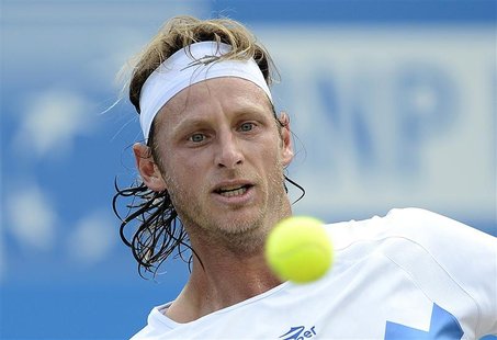 David Nalbandian of Argentina hits a return to Grigor Dimitrov of Bulgaria during their men's singles tennis match at the Queen's Club tourn David Nalbandian of Argentina hits a return to Grigor Dimitrov of Bulgaria during their men's singles tennis match at the Queen's Club tourn