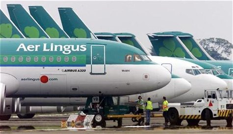 Ground crew are seen parking an Aer Lingus Airbus A320 away from the passenger terminals at Dublin Airport, in the Republic of Ireland in th Ground crew are seen parking an Aer Lingus Airbus A320 away from the passenger terminals at Dublin Airport, in the Republic of Ireland in th