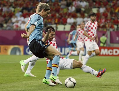 Spain's Fernando Torres (front) is challenged by Croatia's Danijel Pranjic during their Group C Euro 2012 soccer match at the PGE Arena in G Spain's Fernando Torres (front) is challenged by Croatia's Danijel Pranjic during their Group C Euro 2012 soccer match at the PGE Arena in G