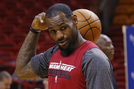 Miami Heat's LeBron James passes a ball over his shoulder during a team practice for the NBA basketball finals in Miami June 18, 2012. REUTE Miami Heat's LeBron James passes a ball over his shoulder during a team practice for the NBA basketball finals in Miami June 18, 2012. REUTE