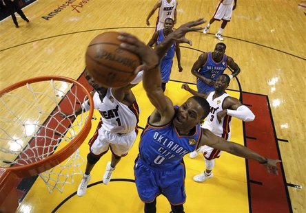 Oklahoma City Thunder's Russell Westbrook (0) scores as Miami Heat's Chris Bosh (L) defends in the first quarter during Game 4 of the NBA ba Oklahoma City Thunder's Russell Westbrook (0) scores as Miami Heat's Chris Bosh (L) defends in the first quarter during Game 4 of the NBA ba