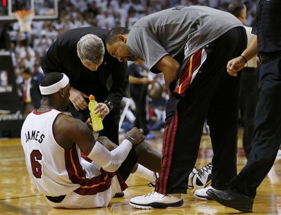 Miami Heat forward LeBron James is helped by teammates and trainers after being injured in the fourth quarter against the Oklahoma City Thun Miami Heat forward LeBron James is helped by teammates and trainers after being injured in the fourth quarter against the Oklahoma City Thun