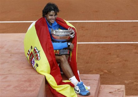 Rafael Nadal of Spain poses with the trophy and the Spanish flag during the ceremony after defeating Roger Federer of Switzerland during the Rafael Nadal of Spain poses with the trophy and the Spanish flag during the ceremony after defeating Roger Federer of Switzerland during the