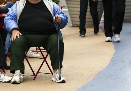 An overweight woman sits on a chair in Times Square in New York, May 8, 2012. America's obesity epidemic is so deeply rooted that it will ta An overweight woman sits on a chair in Times Square in New York, May 8, 2012. America's obesity epidemic is so deeply rooted that it will ta
