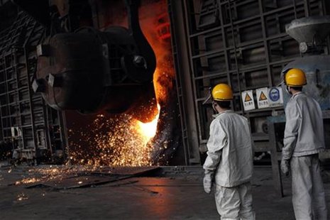 Steel workers stand next to a furnace at the Huaxi Iron and Steel Company plant in Huaxi village, in Jiangsu province October 7, 2011. REUTE Steel workers stand next to a furnace at the Huaxi Iron and Steel Company plant in Huaxi village, in Jiangsu province October 7, 2011. REUTE