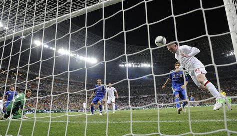 England's Wayne Rooney (R) shoots to score a goal as Ukraine's goalkeeper Andriy Pyatov (L) watches during their Group D Euro 2012 soccer ma England's Wayne Rooney (R) shoots to score a goal as Ukraine's goalkeeper Andriy Pyatov (L) watches during their Group D Euro 2012 soccer ma