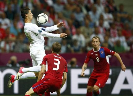 Portugal's Cristiano Ronaldo controls the ball in front of Czech Republic's Michal Kadlec (C) and David Limbersky (R) during their Euro 2012 Portugal's Cristiano Ronaldo controls the ball in front of Czech Republic's Michal Kadlec (C) and David Limbersky (R) during their Euro 2012
