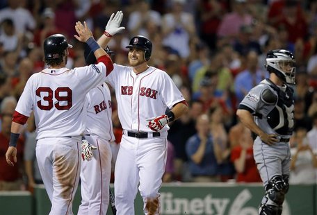 Boston Red Sox Jarrod Saltalamacchia (39) and Will Middlebrooks (C) celebrate beside Miami Marlins catcher Brett Hayes after scoring on Midd Boston Red Sox Jarrod Saltalamacchia (39) and Will Middlebrooks (C) celebrate beside Miami Marlins catcher Brett Hayes after scoring on Midd
