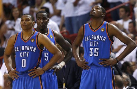 Oklahoma City Thunder's Russell Westbrook (0), Kendrick Perkins (5) and Kevin Durant pause during a time out against the Miami Heat during G Oklahoma City Thunder's Russell Westbrook (0), Kendrick Perkins (5) and Kevin Durant pause during a time out against the Miami Heat during G