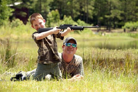 Jeremy Chavez helps his son Ryan, 6, with target practice before a wild hog hunt at Great Southern Outdoors Wildlife Plantation in Union Spr Jeremy Chavez helps his son Ryan, 6, with target practice before a wild hog hunt at Great Southern Outdoors Wildlife Plantation in Union Spr