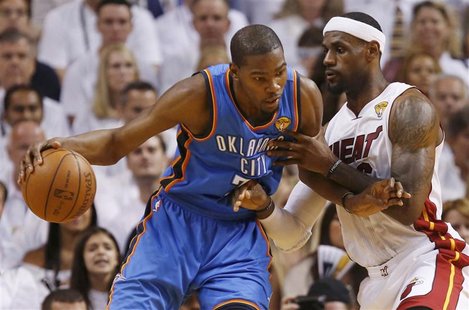 Oklahoma City Thunder's Kevin Durant (L) is guarded by Miami Heat's LeBron James during the first quarter in Game 5 of the NBA basketball fi Oklahoma City Thunder's Kevin Durant (L) is guarded by Miami Heat's LeBron James during the first quarter in Game 5 of the NBA basketball fi