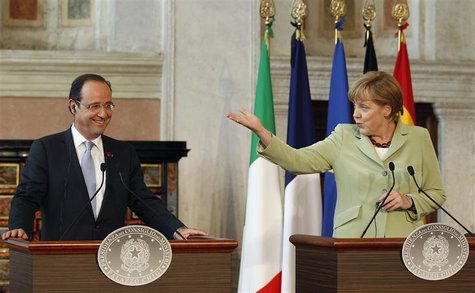 German Chancellor Angela Merkel (R) gestures next to French President Francois Hollande during a news conference at Villa Madama in Rome, Ju German Chancellor Angela Merkel (R) gestures next to French President Francois Hollande during a news conference at Villa Madama in Rome, Ju