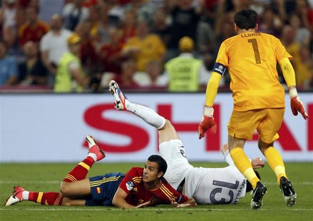 Spain's Pedro Rodriguez (L) lies on the ground after he was fouled during their Euro 2012 quarter-final soccer match against France at the D Spain's Pedro Rodriguez (L) lies on the ground after he was fouled during their Euro 2012 quarter-final soccer match against France at the D