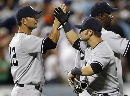 New York Yankees' Eric Chavez (L) and teammate Nick Swisher celebrate their win against the New York Mets in their MLB Interleague baseball New York Yankees' Eric Chavez (L) and teammate Nick Swisher celebrate their win against the New York Mets in their MLB Interleague baseball