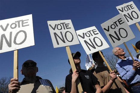 Protesters hold signs as several groups hold a "Kill the Bill" rally against President Barack Obama's health care legislation, on the west f Protesters hold signs as several groups hold a "Kill the Bill" rally against President Barack Obama's health care legislation, on the west f