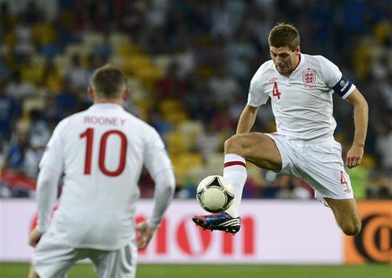 England's Steven Gerrard (R) controls the ball next to team mate Wayne Rooney during their Euro 2012 quarter-final soccer match against Ital England's Steven Gerrard (R) controls the ball next to team mate Wayne Rooney during their Euro 2012 quarter-final soccer match against Ital
