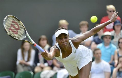 Venus Williams of the U.S. hits a return to Elena Vesnina of Russia during their women's singles tennis match at the Wimbledon tennis champi Venus Williams of the U.S. hits a return to Elena Vesnina of Russia during their women's singles tennis match at the Wimbledon tennis champi