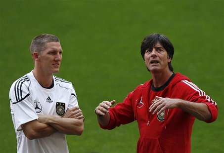 Germany's national soccer coach Joachim Loew (R) talks to his player Bastian Schweinsteiger during a training session at Turk Telekom Arena Germany's national soccer coach Joachim Loew (R) talks to his player Bastian Schweinsteiger during a training session at Turk Telekom Arena