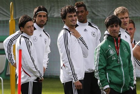 Germany's national soccer players Mesut Oezil, Sami Khedira, Mats Hummels, Jerome Boateng, coach Joachim Loew, Holger Badstuber and Mario Go Germany's national soccer players Mesut Oezil, Sami Khedira, Mats Hummels, Jerome Boateng, coach Joachim Loew, Holger Badstuber and Mario Go