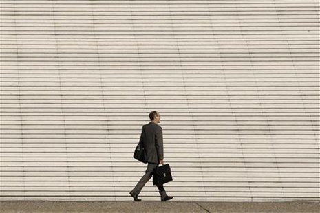 A businessman walks past the steps at the Arche de la Defense, the financial and business district west of Paris, August 5, 2009. REUTERS/Be A businessman walks past the steps at the Arche de la Defense, the financial and business district west of Paris, August 5, 2009. REUTERS/Be