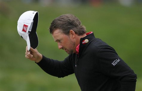 Graeme McDowell doffs his cap while walking up to the 18th green during the final round of the 2012 U.S. Open golf tournament on the Lake Co Graeme McDowell doffs his cap while walking up to the 18th green during the final round of the 2012 U.S. Open golf tournament on the Lake Co