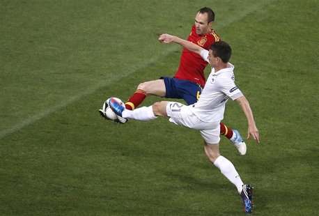 Spain's Andres Iniesta (L) fights for the ball with France's Laurent Koscielny during their Euro 2012 quarter-final soccer match at the Donb Spain's Andres Iniesta (L) fights for the ball with France's Laurent Koscielny during their Euro 2012 quarter-final soccer match at the Donb