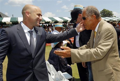 Andre Agassi (L) hugs coach Nick Bollettieri after Agassi was inducted into the International Tennis Hall of Fame in Newport, Rhode Island J Andre Agassi (L) hugs coach Nick Bollettieri after Agassi was inducted into the International Tennis Hall of Fame in Newport, Rhode Island J