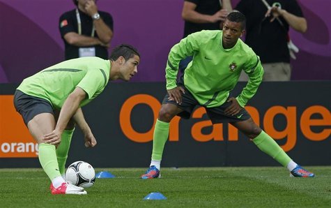 Portugal's Christiano Ronaldo (L) and Nani stretch at a training session during the Euro 2012 at new Lviv stadium June 8, 2012. REUTERS/Eddi Portugal's Christiano Ronaldo (L) and Nani stretch at a training session during the Euro 2012 at new Lviv stadium June 8, 2012. REUTERS/Eddi