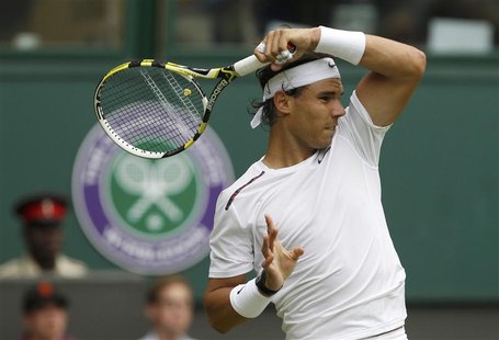 Rafael Nadal of Spain hits a return to Thomaz Bellucci of Brazil during their men's singles tennis match at the Wimbledon tennis championshi Rafael Nadal of Spain hits a return to Thomaz Bellucci of Brazil during their men's singles tennis match at the Wimbledon tennis championshi