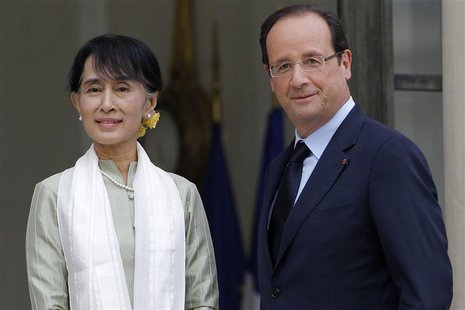 Myanmar pro-democracy leader Aung San Suu Kyi (L) is welcomed by French President Francois Hollande as she arrives on the first day of a thr Myanmar pro-democracy leader Aung San Suu Kyi (L) is welcomed by French President Francois Hollande as she arrives on the first day of a thr