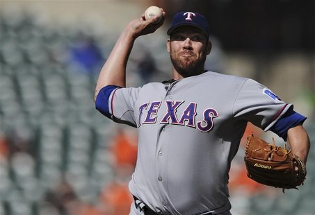 Texas Rangers starting pitcher Colby Lewis works the second inning against the Baltimore Orioles in their first game of a doubleheader durin Texas Rangers starting pitcher Colby Lewis works the second inning against the Baltimore Orioles in their first game of a doubleheader durin